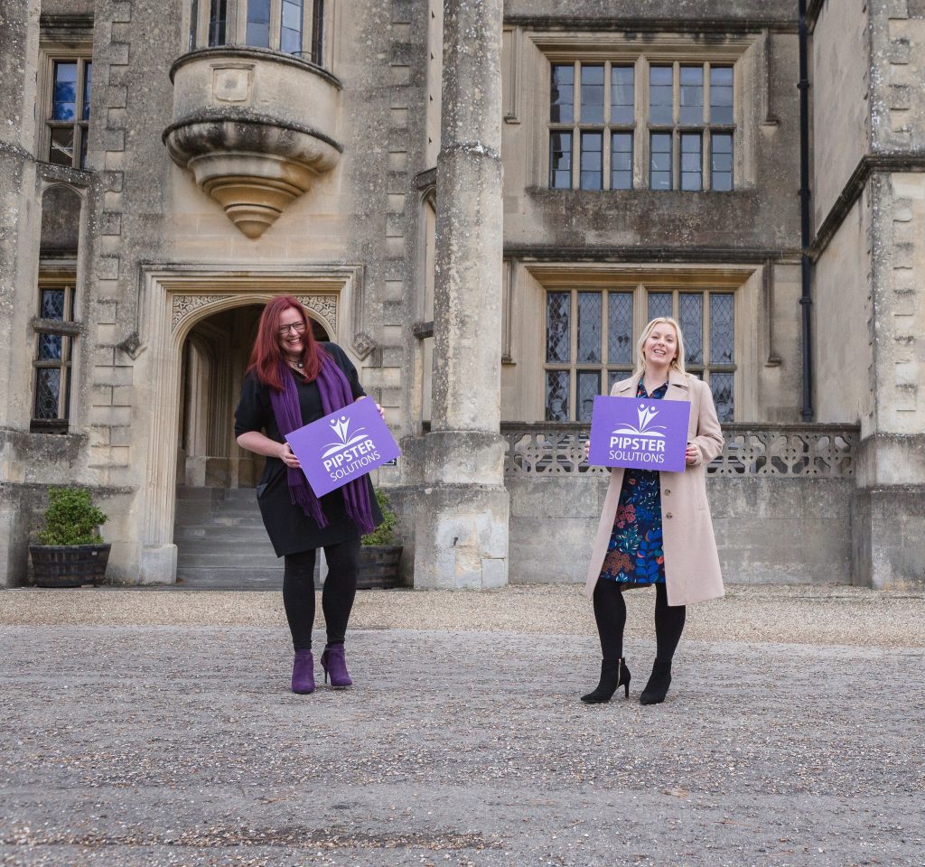 Pipster team holding branded signage